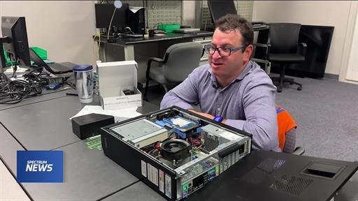 Technician troubleshooting a laptop